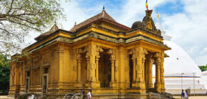 People walk at Kelaniya Temple in Colombo, Sri Lanka on a sunny day.